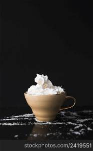 coffee cup with whipped cream black surface