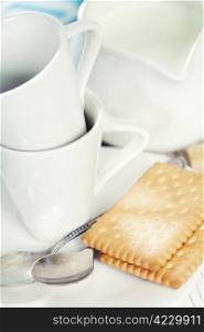 Coffee cups, milk and cookies