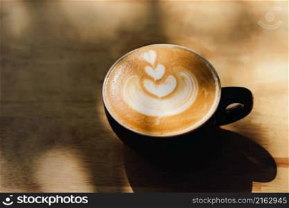 coffee cups with latte art on wood background