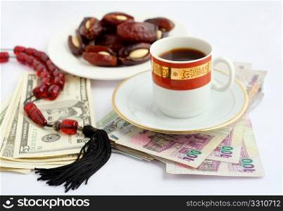 Coffee, dates stuffed with almonds and worry beads, on piles of Qatari Arab money and US dollars. Sweet food and coffee are inevitable accompaniments to any business dealings in the arab world