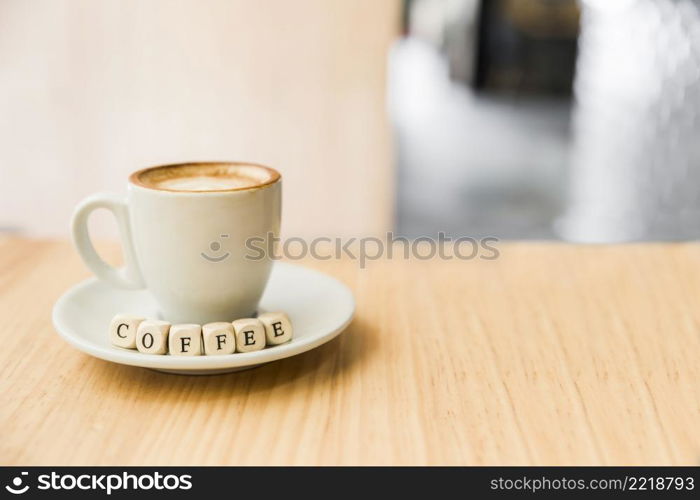 coffee dice with cup coffee wooden desk