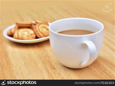 Coffee drink is on wooden table with cookie in coffee time