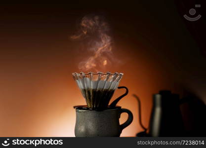 Coffee Drip Concept. Dripper, Mug and Kettle with Motion Steam. Dramatic lighting in Studio