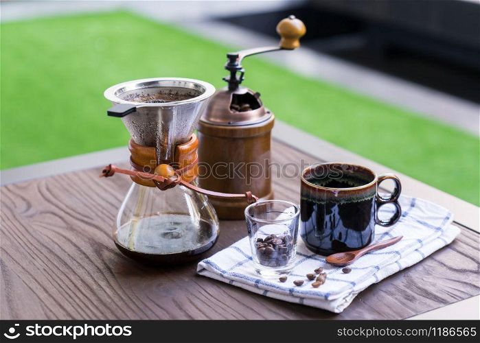Coffee drip equipment set on wooden table.