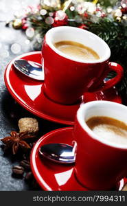 Coffee Espresso. Red Cups Of Coffee and Christmas decorations on dark background