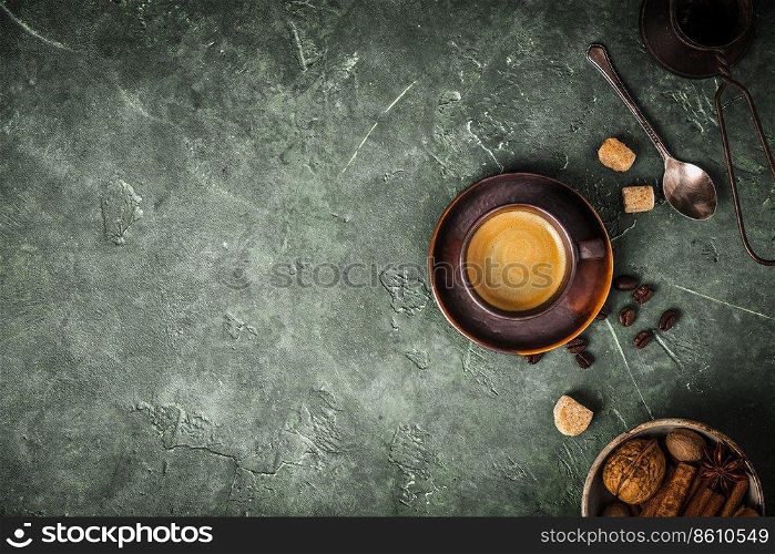 Coffee, flowers and spices on old green background, flat lay, space for text