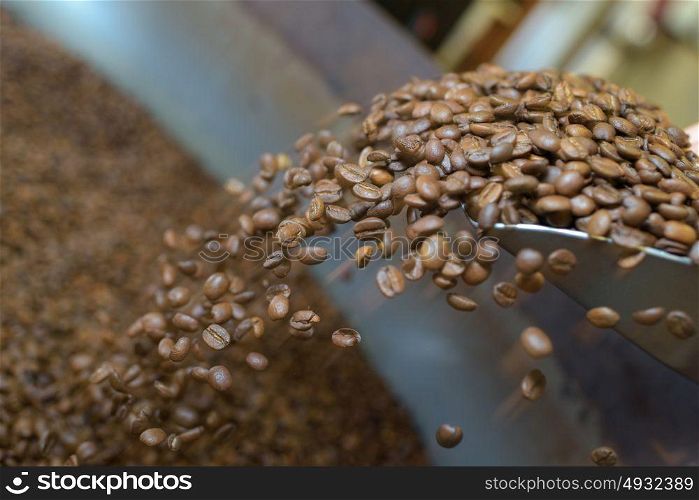 Coffee grains falling from scoop