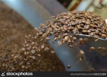 Coffee grains falling from scoop