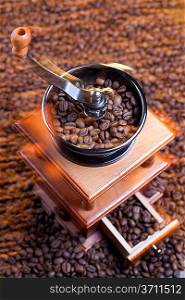 Coffee grinder with coffee beans. Mixed with different lights.