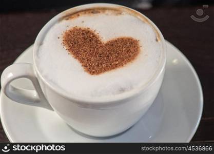 Coffee heart shape. Coffee cup with milk and heart shape