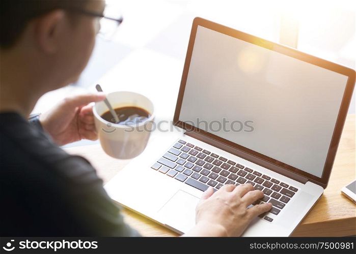 Coffee in businessman hand with Laptop .