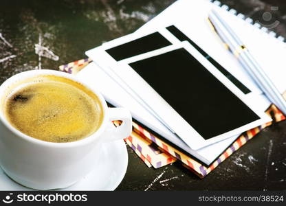 coffee in cup and sheets for note