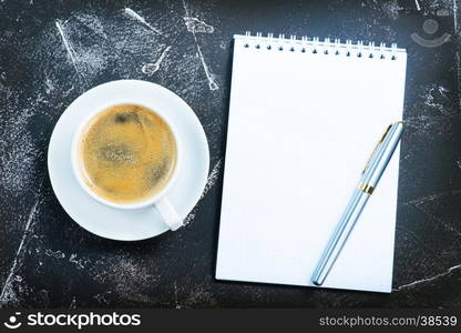 coffee in cup and sheets for note