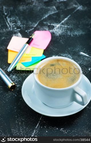 coffee in cup and sheets for note