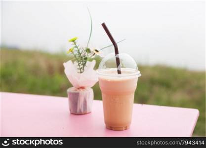 Coffee in plastic cup. Iced coffee in a plastic cup is placed on the table.