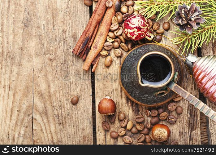 Coffee in retro cezve and christmas decoration. Christmas coffe and toy