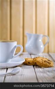 coffee in the cup and cookie, milk bowl on white old table