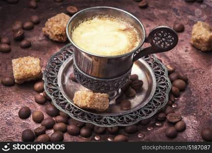 Coffee in the oriental style. Vintage set with a cup of coffee on saucer in oriental style