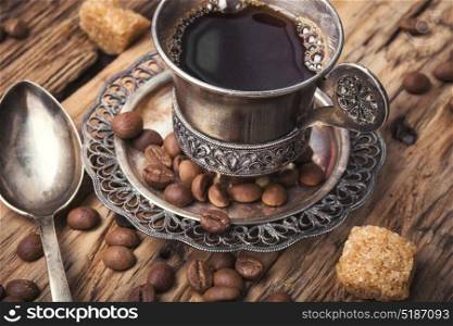 Coffee in the oriental style. Vintage set with a cup of coffee on saucer in oriental style