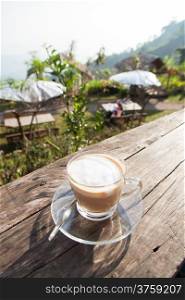 Coffee laid on wooden terrace In the early morning hours The sunlight shines down