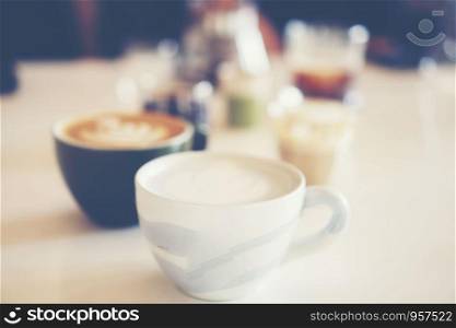 coffee latte art in coffee cup, vintage filter image