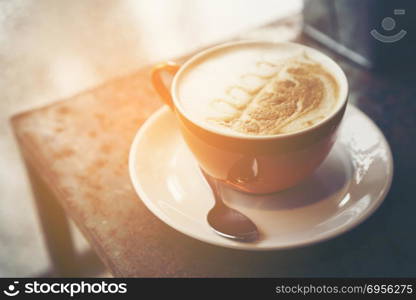 coffee latte art in coffee shop cafe, vintage filter image