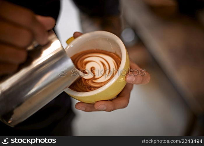 coffee latte art making by barista . Hot latte art making by barista