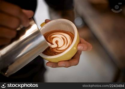 coffee latte art making by barista . Hot latte art making by barista