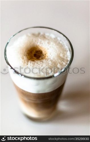 Coffee latte in a tall glass on white background shallow depth of field