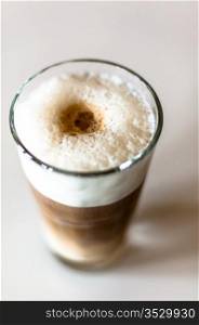 Coffee latte in a tall glass on white background shallow depth of field