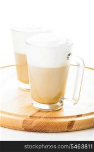 Coffee latte in glass mugs on the board
