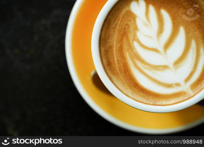 Coffee Latte leaf pattern face on black table