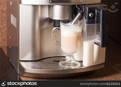 Coffee machine brewing a cappuccino in glass. Homemade latte Espresso