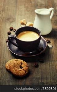 Coffee, milk and cookies on wooden background