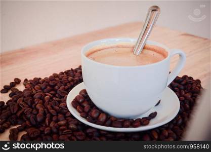 coffee milk Latte with beans on wooden table for coffee shop concept,Food and drink