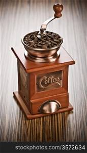 coffee mill on wooden background