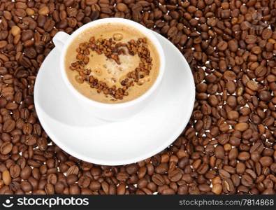 coffee mug against the backdrop of coffee beans. heart
