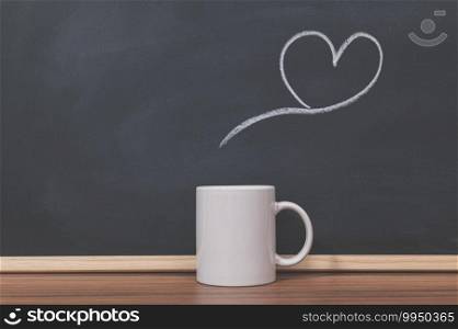 Coffee mugs and heart shapes on the blackboard