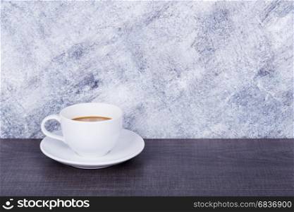 coffee on wood table and concrete wall background