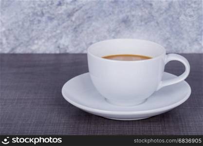 coffee on wood table and concrete wall background