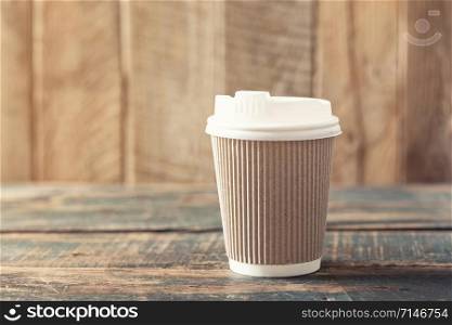 Coffee or tea in a paper cup with a lid