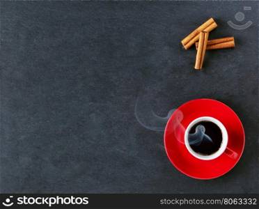 Coffee red cup and cinnamon on black table. Coffee red cup and cinnamon