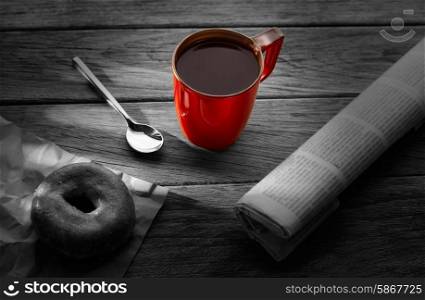 Coffee red cup newspaper and dona morning breakfast on vintage wooden table