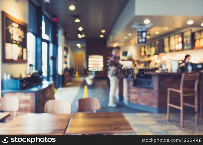 Coffee shop and people sit on table. Blur background image.