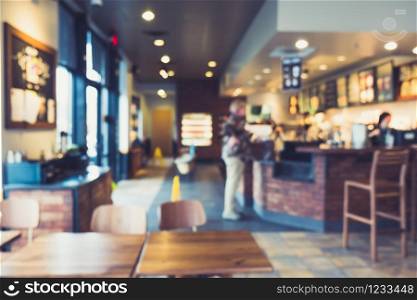 Coffee shop and people sit on table. Blur background image.