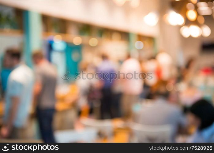 Coffee shop interior with people as blurred cafe background