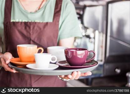 Coffee shop owner serving set of freshly brewed coffee, stock photo