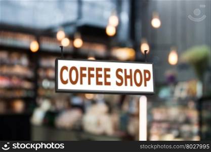 Coffee shop signboard with coffee shop blurred background with bokeh