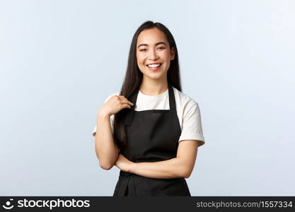 Coffee shop, small business and startup concept. Happy and friendly asian female barista in black apron smiling at client, listening to order, staff at cafe prepare drinks for customers.. Coffee shop, small business and startup concept. Happy and friendly asian female barista in black apron smiling at client, listening to order, staff at cafe prepare drinks for customers