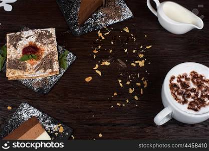 Coffee theme photo. Table with cakes ans coffee cup